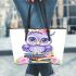 Cute purple owl sitting on top of books with pink roses leather tote bag