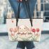 Cute white rabbit sitting on the swing leather tote bag