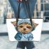 Cute yorkshire terrier in hoodie leather tote bag