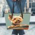 Cute yorkshire terrier puppy driving an old brown convertible car leather tote bag