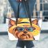 Cute yorkshire terrier wearing summer leather tote bag