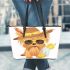 Cute yorkshire terrier wearing summer leather tote bag