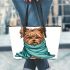 Cute yorkshire terrier wrapped in teal blanket leather tote bag