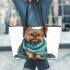 Cute yorkshire terrier wrapped in teal blanket leather tote bag