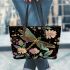 Dragonfly is flying surrounded by flowers leather tote bag