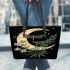 Green dragonflies flying around the moon leather tote bag