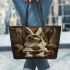 Green frog in a white bunny costume sitting on a chair leaather tote bag