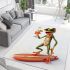 Happy frog wearing sunglasses surfing on a surfboard while holding area rugs carpet