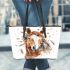 Indian horse with white feathers in its mane leather tote bag