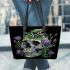 Skull with green frog on top and purple thistle flowers growing leaather tote bag