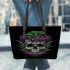 Skull with green frog on top and purple thistles growing leaather tote bag