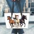 Three horses galloping in the wind leather tote bag