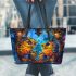 Two colorful owls sitting on the edge of an ornate mirror leather tote bag