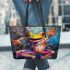 Vibrant painting of an happy dancing frog leaather tote bag