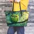 An owl with green feathers perched on the branch of an tree leather tote bag