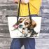 Beagle puppy holding a pink rose in its mouth leather tote bag