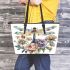 Beautiful dragonfly sitting on top of flowers leather tote bag