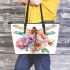 Beautiful dragonfly sitting on top of flowers leather tote bag