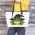 Cartoon green frog wearing black witch hat leaather tote bag