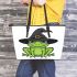 Cartoon green frog wearing black witch hat leaather tote bag