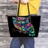 Colorful owl with glowing eyes perched leather tote bag