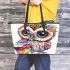 Cute baby owl with big eyes wearing leather tote bag