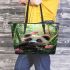 Cute baby panda is eating bamboo leaves in the forest leather tote bag