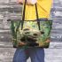 Cute baby panda is eating bamboo leaves in the forest leather tote bag