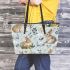 Cute bunnies and flowers on light blue leather tote bag