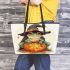 Cute cartoon frog wearing a witch hat sitting on a pumpkin leaather tote bag