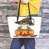 Cute cartoon frog wearing a witch's hat sitting on a pumpkin leaather tote bag