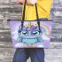 Cute cartoon owl with big eyes wearing an oversized sweater leather tote bag