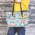 Cute cartoon owls with cute hats sitting on tree branches leather tote bag