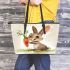 Cute cartoon rabbit holding a carrot leather tote bag