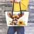 Cute chihuahua puppy with big eyes sitting next to sunflower leather tote bag