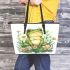 Cute frog sitting on the grass with flowers leaather tote bag