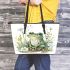 Cute frog sitting on the ground with flowers leaather tote bag