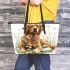 Cute golden retriever dog with easter eggs leather tote bag