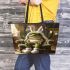 Cute green frog sitting in an armchair wearing white bunny slippers leaather tote bag