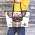 Cute grey french bulldog dog wearing a pink flower leather tote bag