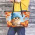 Cute owl in blue hat sitting on the log surrounded leather tote bag