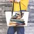 Cute owl sitting on top of books leather tote bag