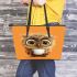 Cute owl with big eyes holding a white coffee cup leather tote bag