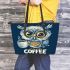 Cute owl with big yellow eyes holding a coffee cup leather tote bag