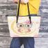 Cute pink owl with a bow and glasses sitting on the moon leather tote bag