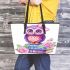 Cute purple owl sitting on top of books with pink roses leather tote bag