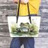 Cute smiling frog sitting in the grass near water leaather tote bag