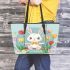 Cute white rabbit sitting on the swing leather tote bag