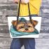 Cute yorkshire terrier dog peeking leather tote bag