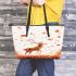 Deer with falling leaves in an autumn forest leather totee bag